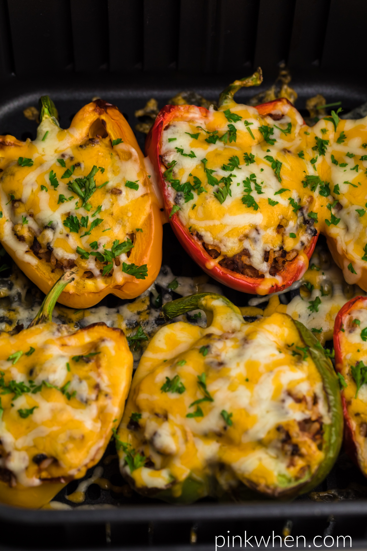 Stuffed peppers in the air fryer topped with fresh parsley and ready to serve. 
