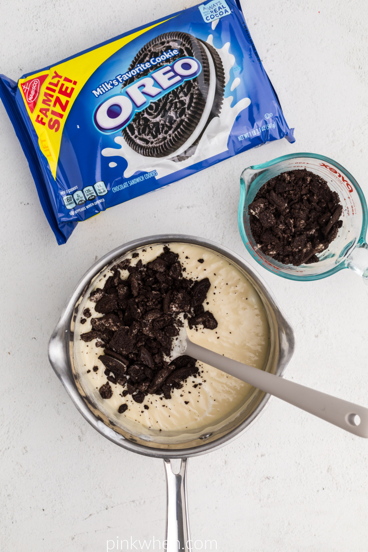 Crushed OREOs being added to the white chocolate fudge mixture. 