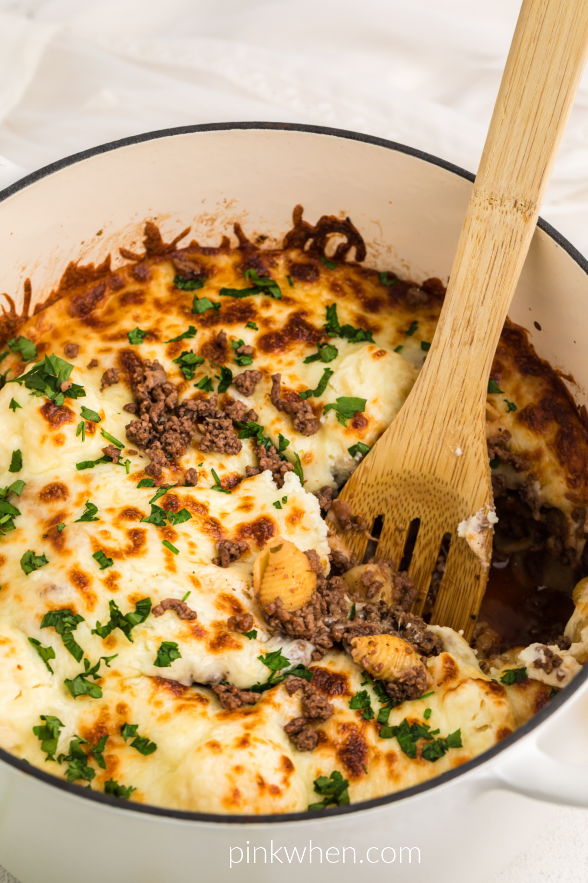 One pot lasagna with a scoop of lasagna missing.