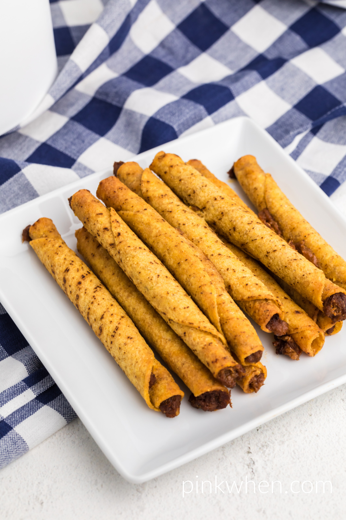 Air Fries taquitos on a white plate ready to serve.
