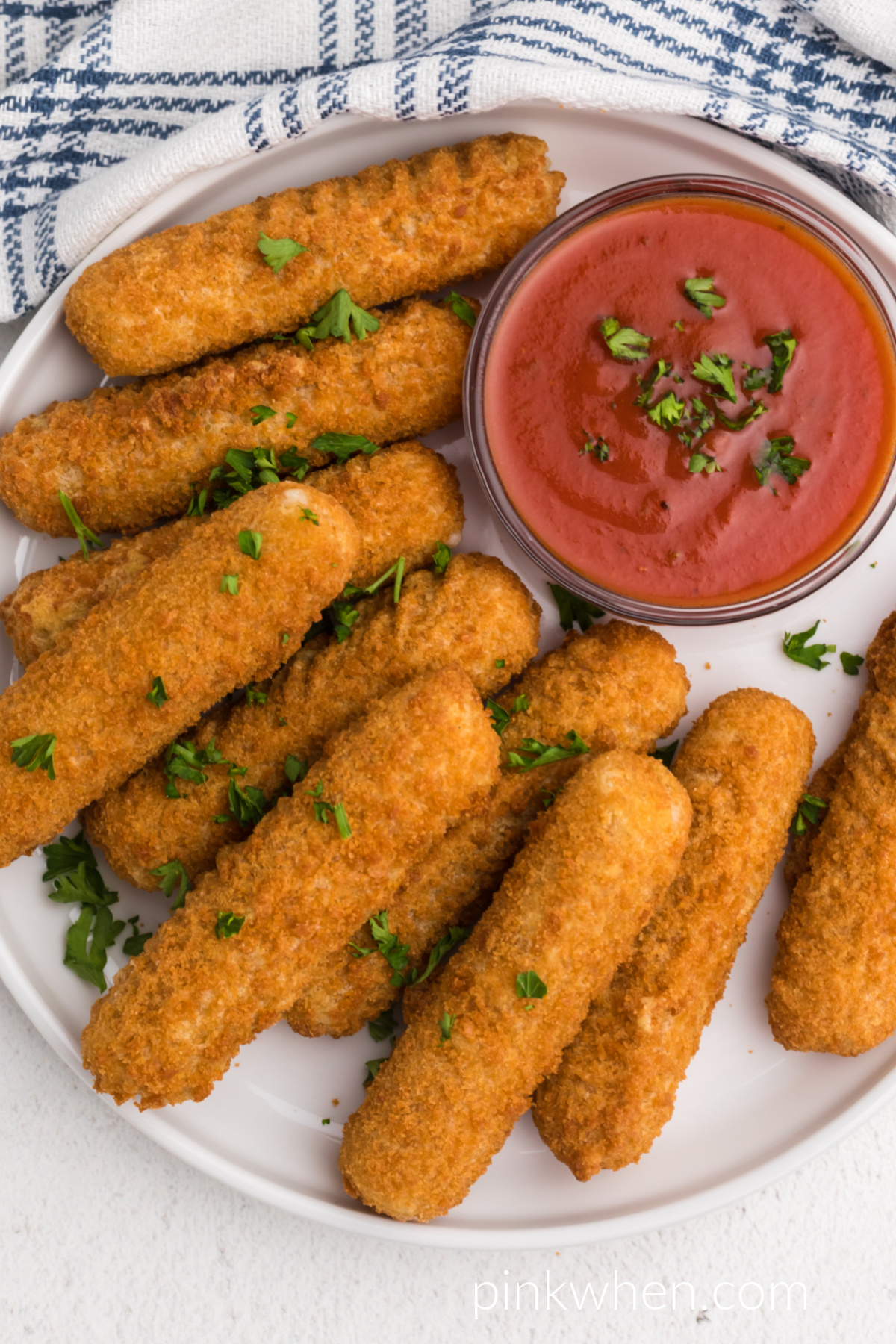 Close up overhead shot of gooey mozzarella sticks in the air fryer. 
