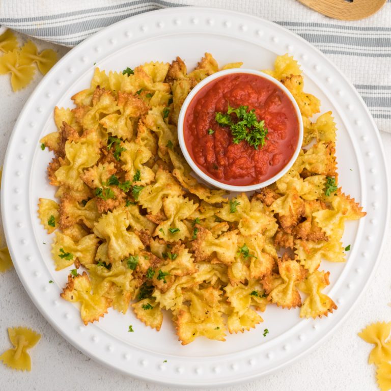 Overhead shot of pasta chips made in the air fryer and served on a white plate.
