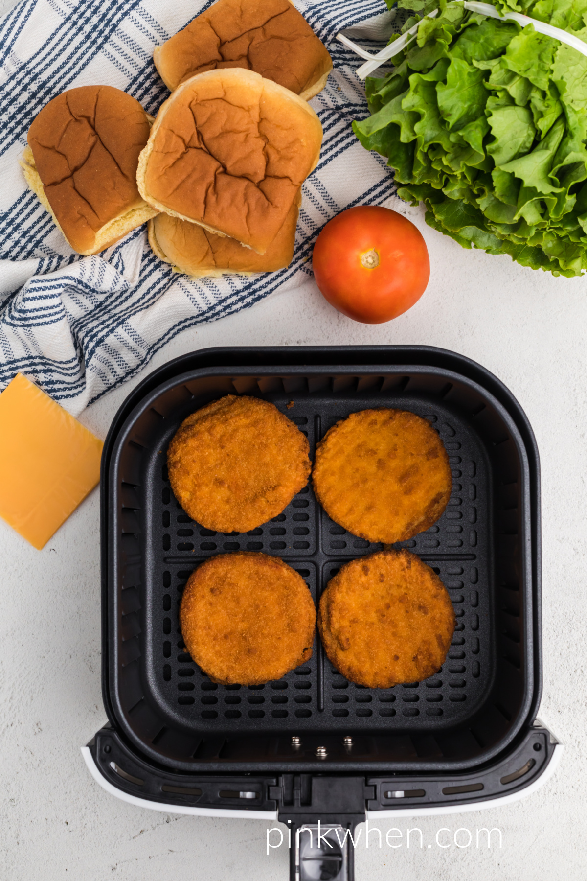 Chicken patties in the basket of the air fryer, ready to be served. 