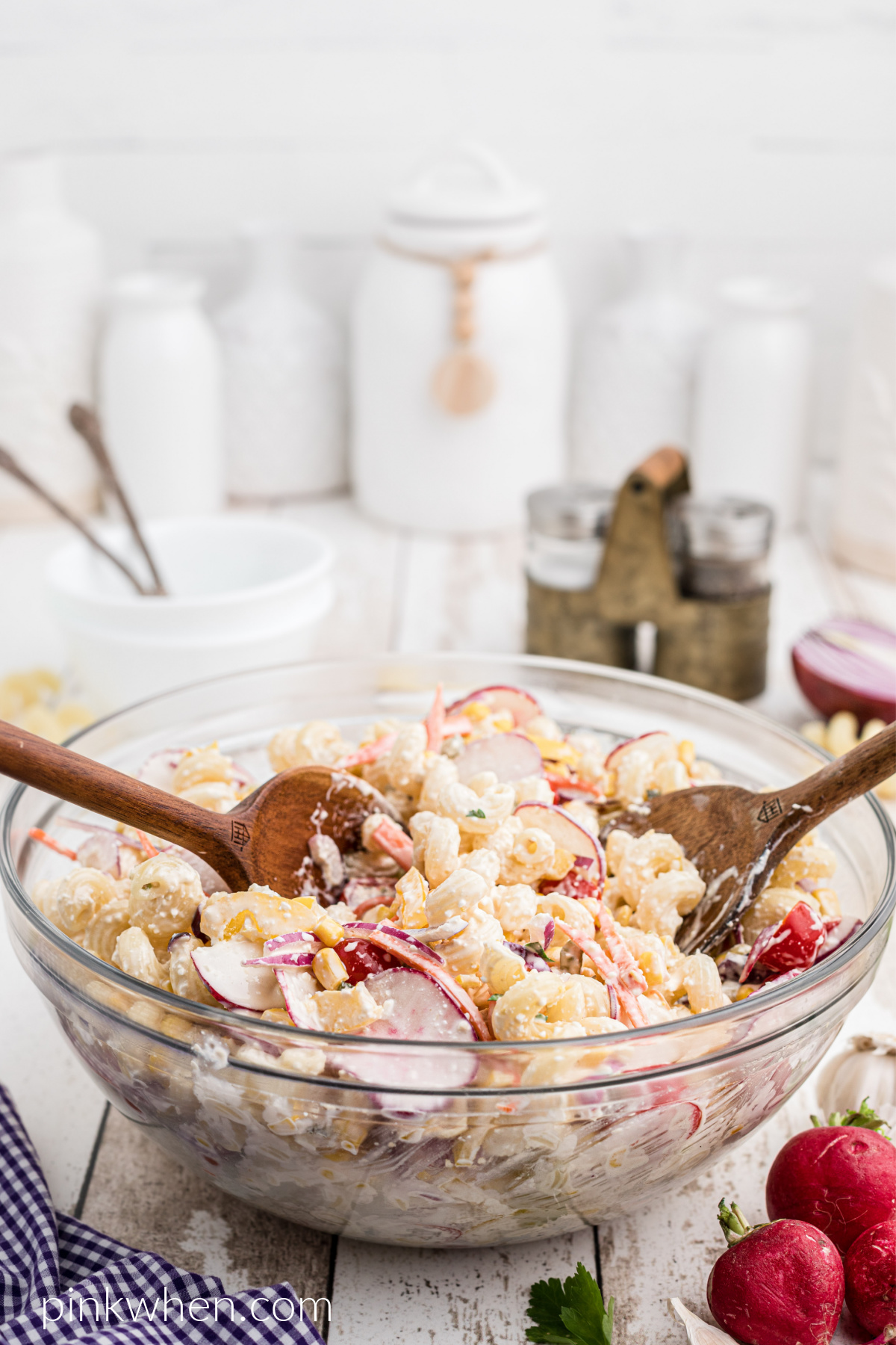 Summer Pasta Salad with wooden spoons ready to serve. 