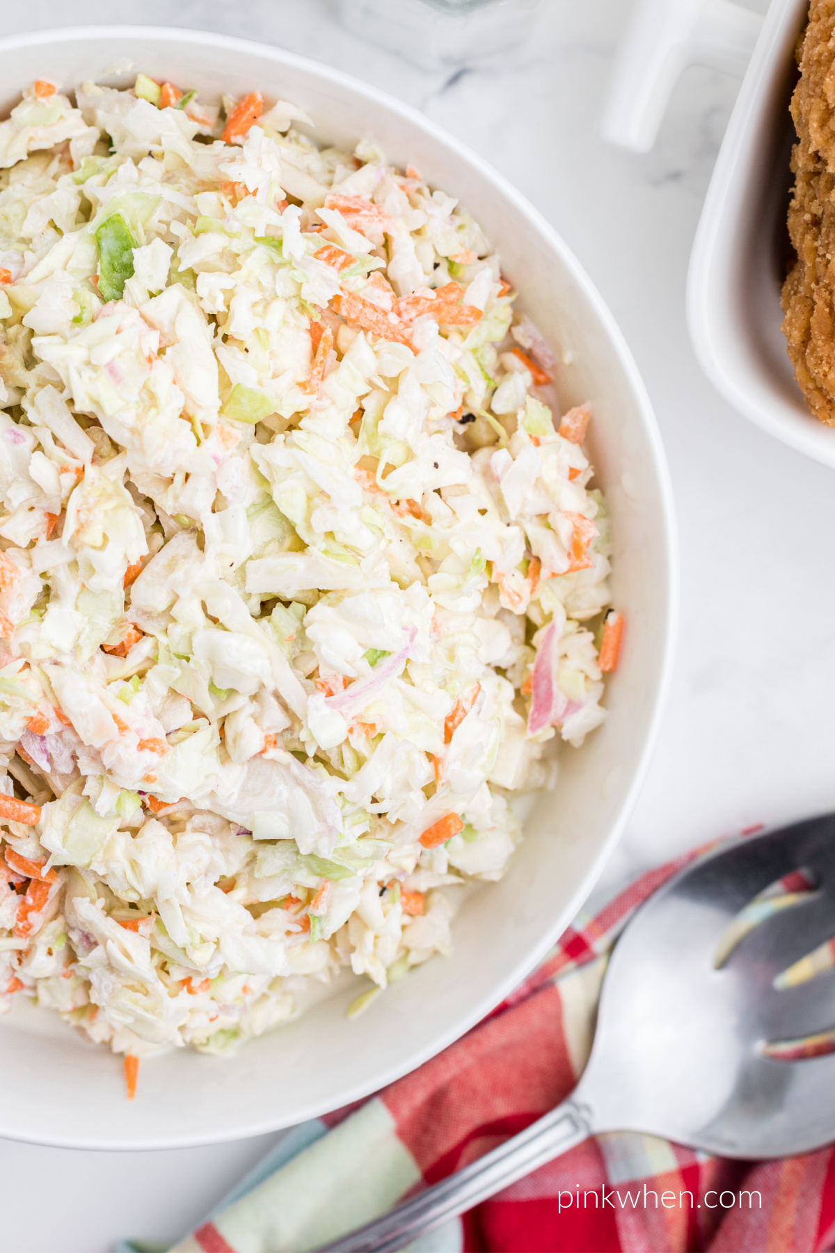 Copycat KFC coleslaw in a white bowl ready to serve.