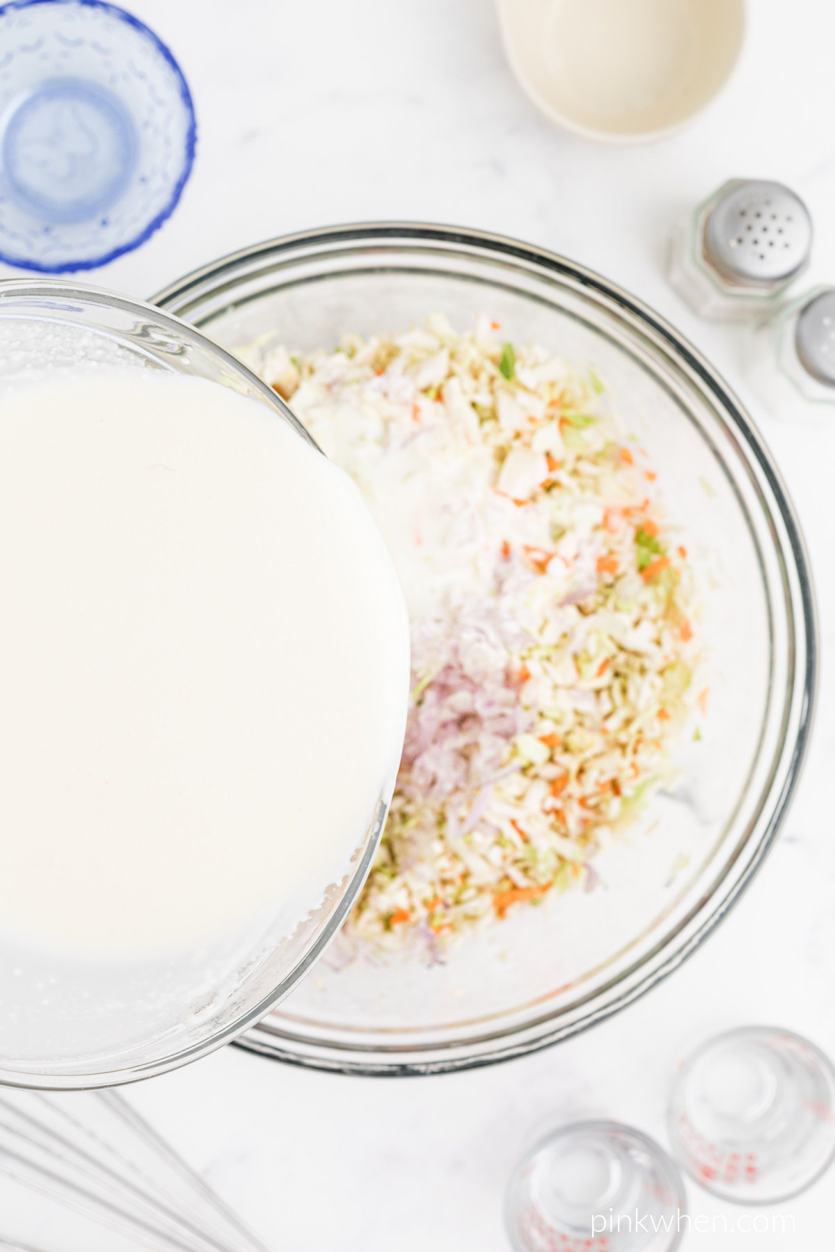 mixture being added to the coleslaw.