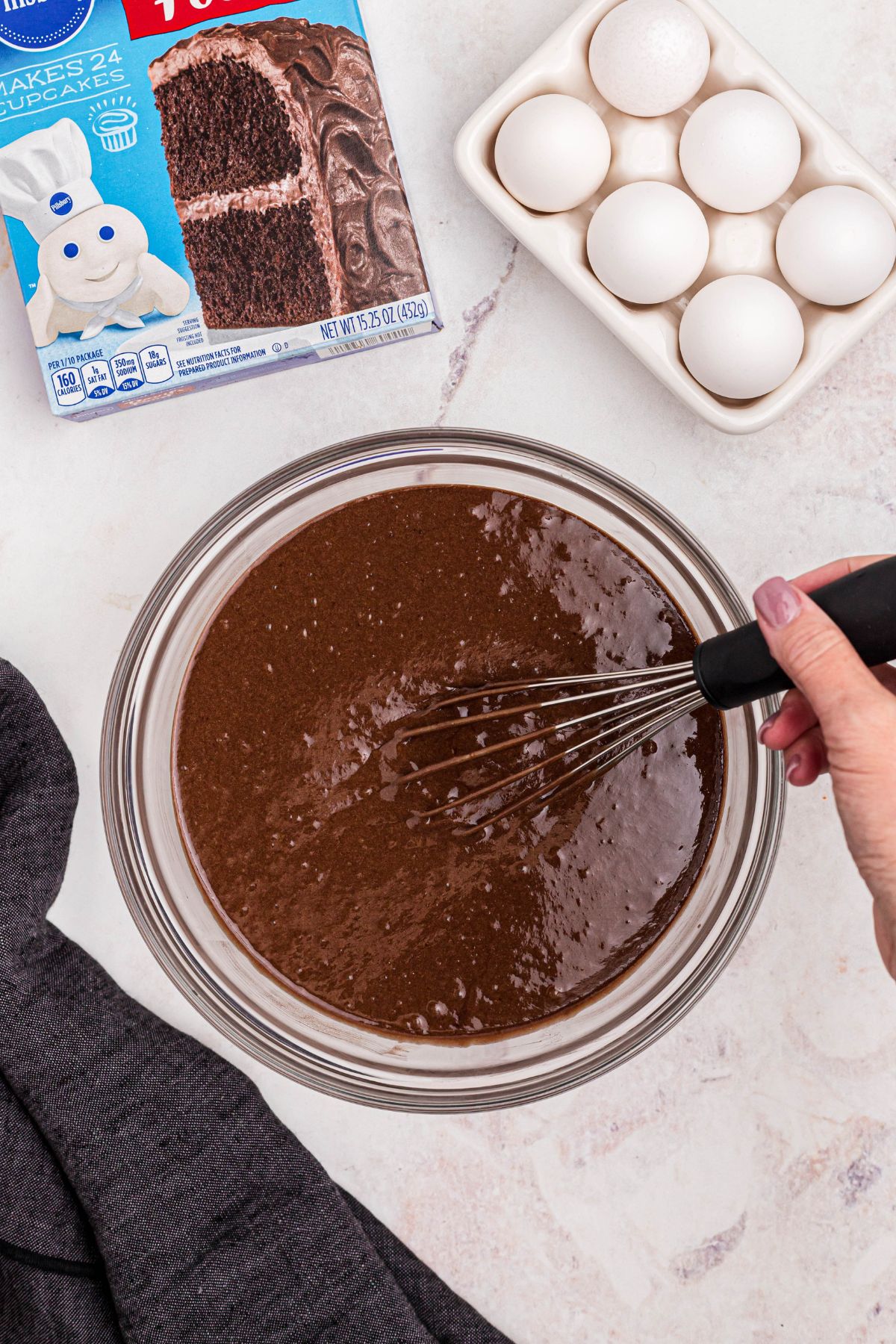 Devil's food cake mix being made in a clear glass bowl. 