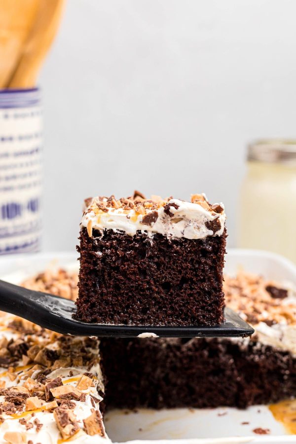 Slice of chocolate cake being taken out with a spatula.
