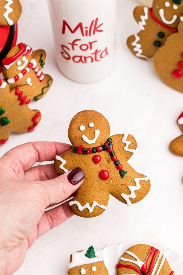 Golden gingerbread cookies decorated with red and green frosting. 
