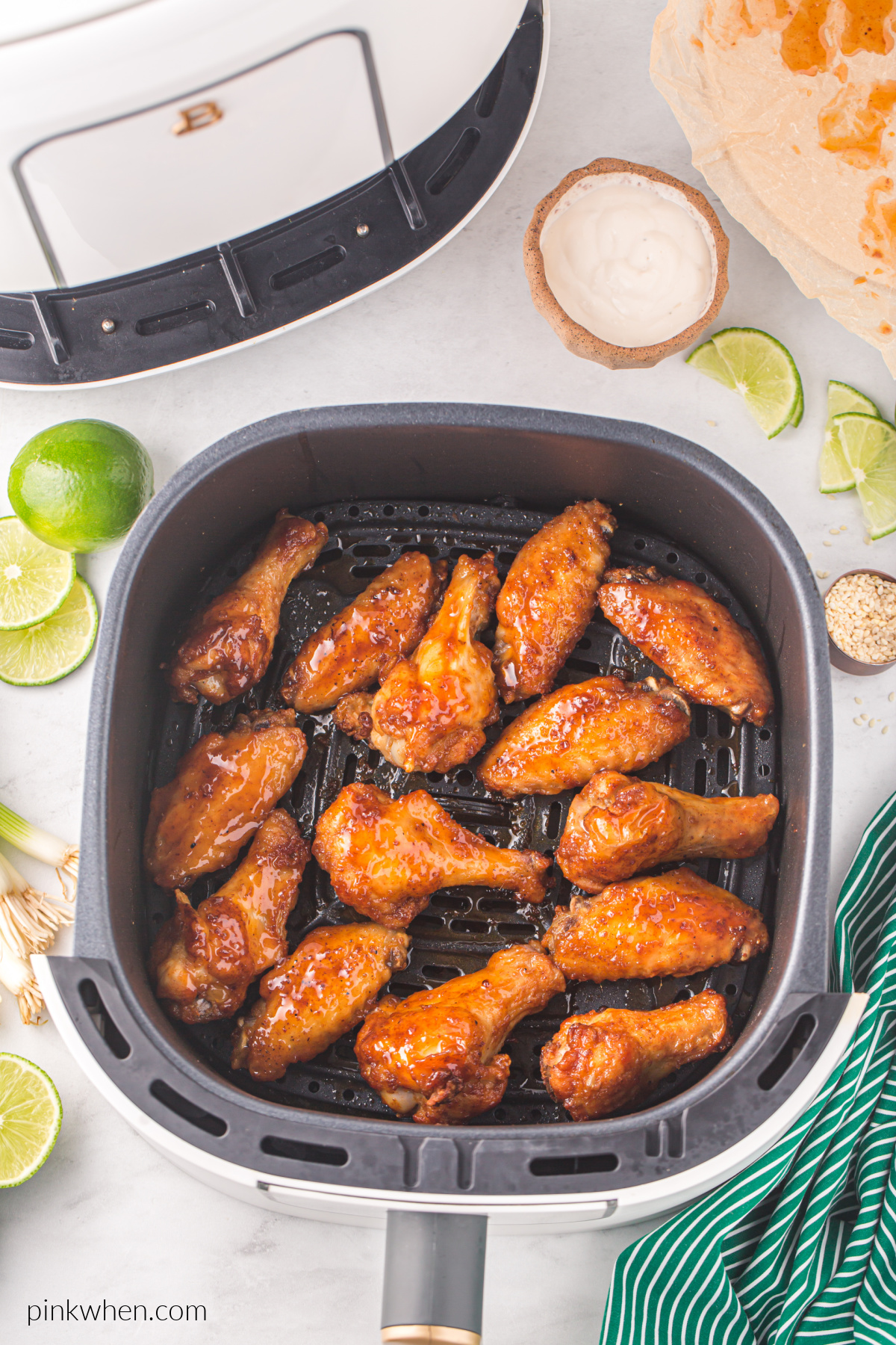 Honey sriracha wings in air fryer basket. 