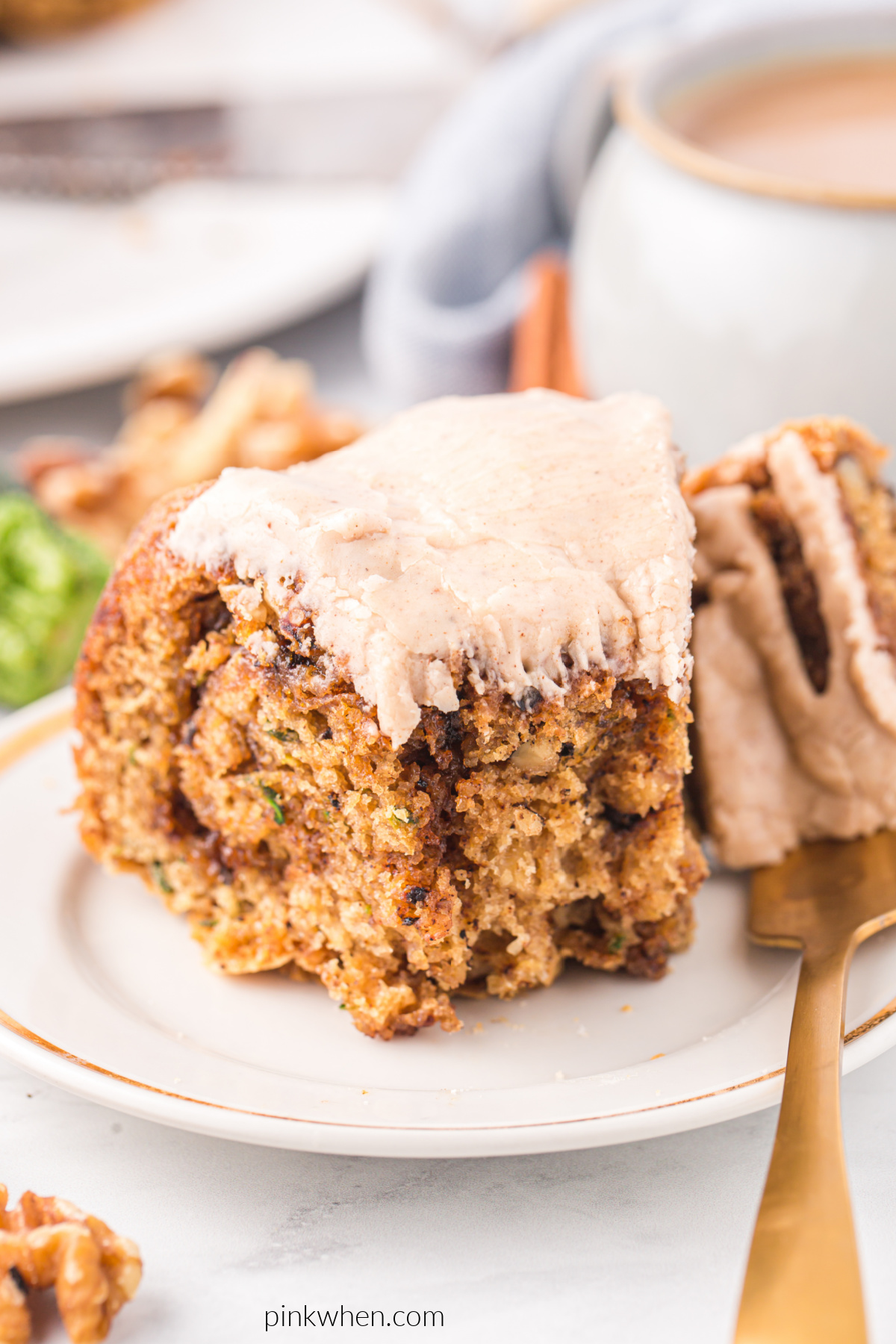 Close up photo of a bite taken from a slice of zucchini bundt cake. 