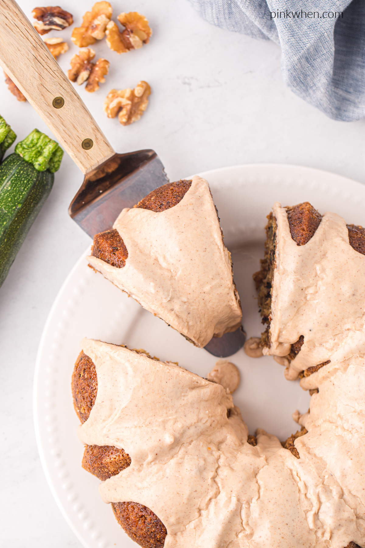 Sliced zucchini bundt cake with cinnamon icing. 
