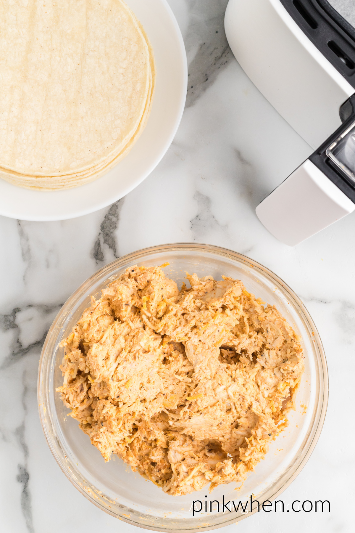 cream cheese, chicken, and taco seasoning combined in a bowl.