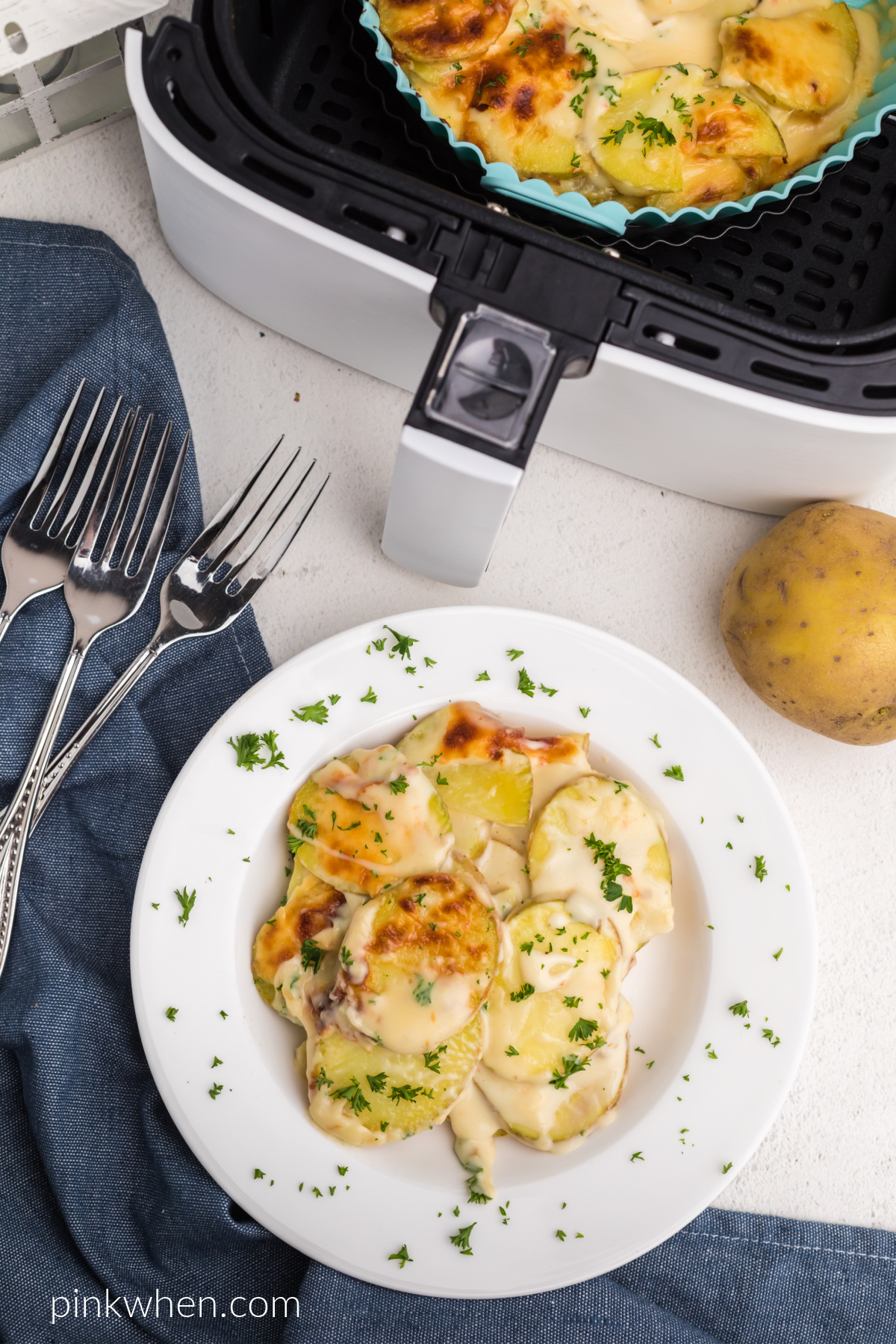 Scalloped potatoes made in the air fryer scooped into a bowl and ready to serve.