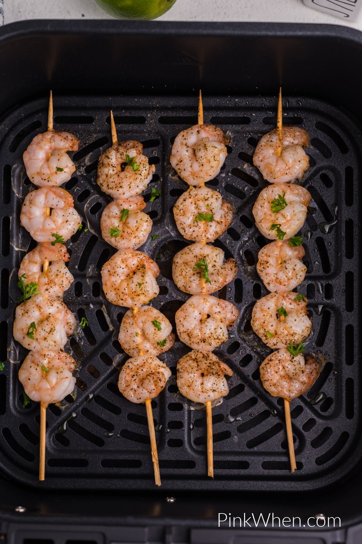 Shrimp skewers in the air fryer basket, ready to be served. 
