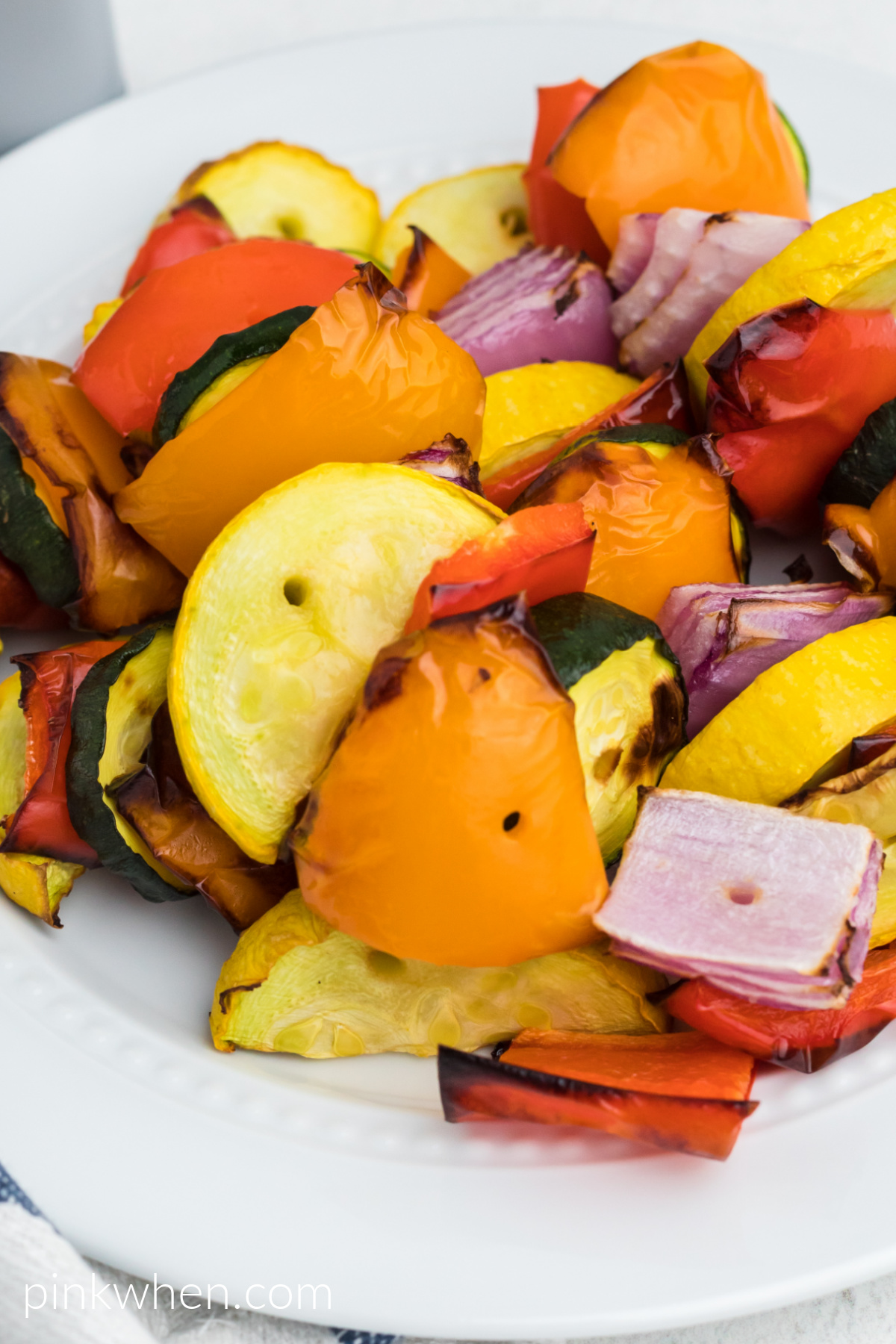 Close up photo of vegetables in a bowl, removed from skewers. Ready to eat.