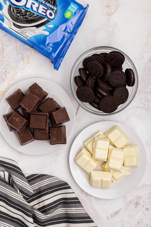 Chocolate, white chocolate and Oreos in a marble table. 