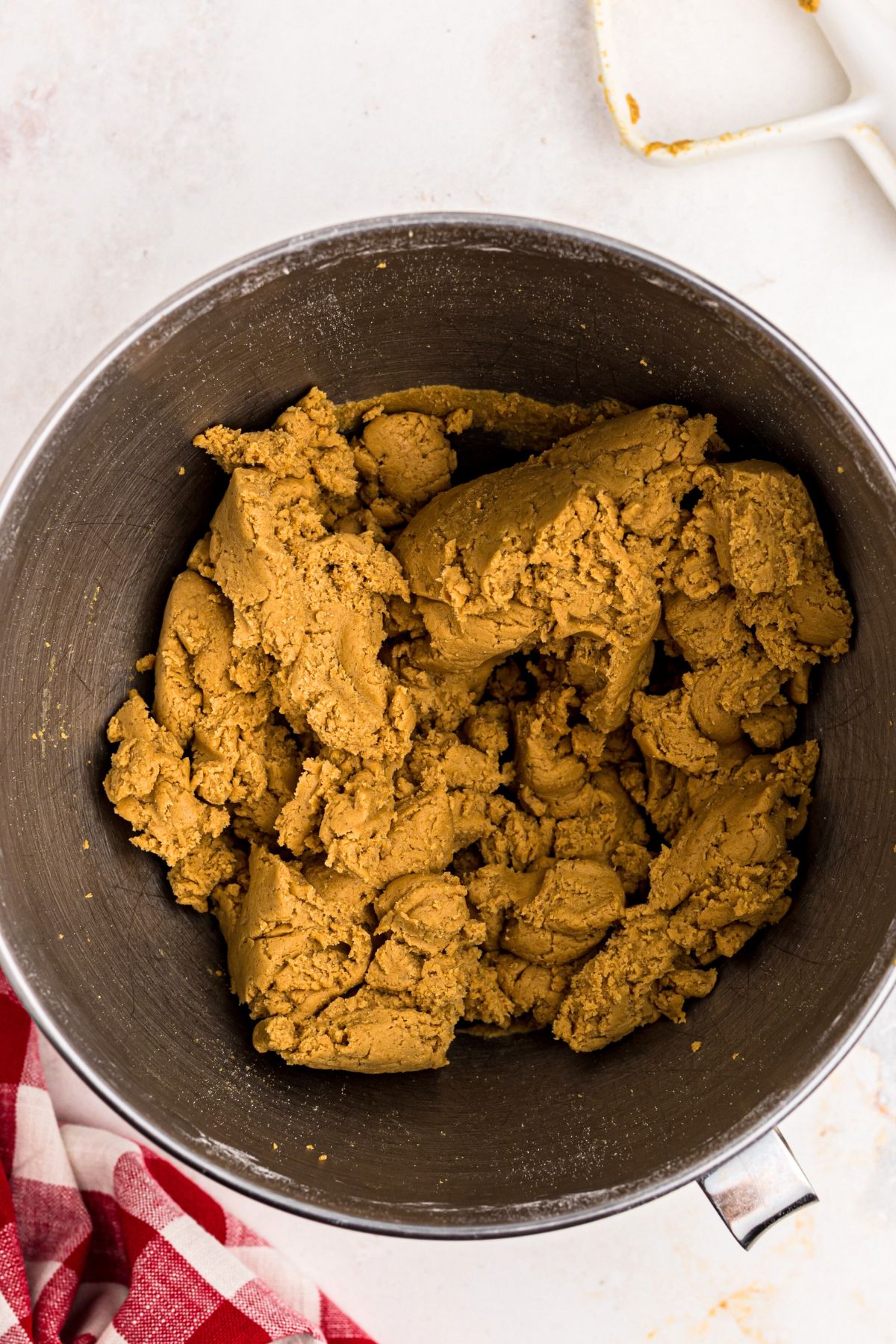 Uncooked gingerbread cookie dough in a mixing bowl.
