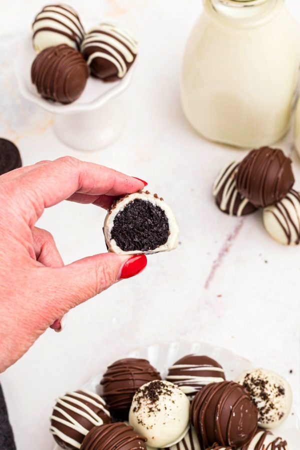 Hand holding Oreo ball cut in half