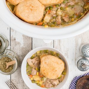 Overhead shot of slow cooker chicken pot pie in the crock pot and in a bowl ready to serve.