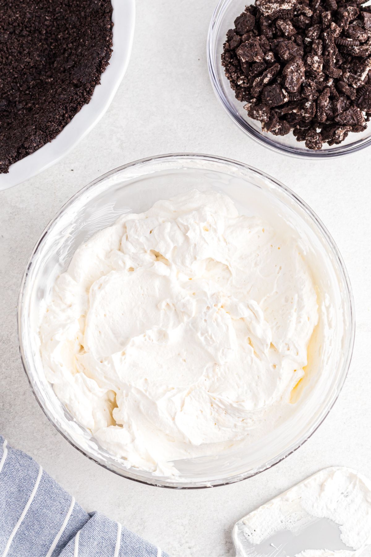 Whipped cream being mixed with cream cheese mixture