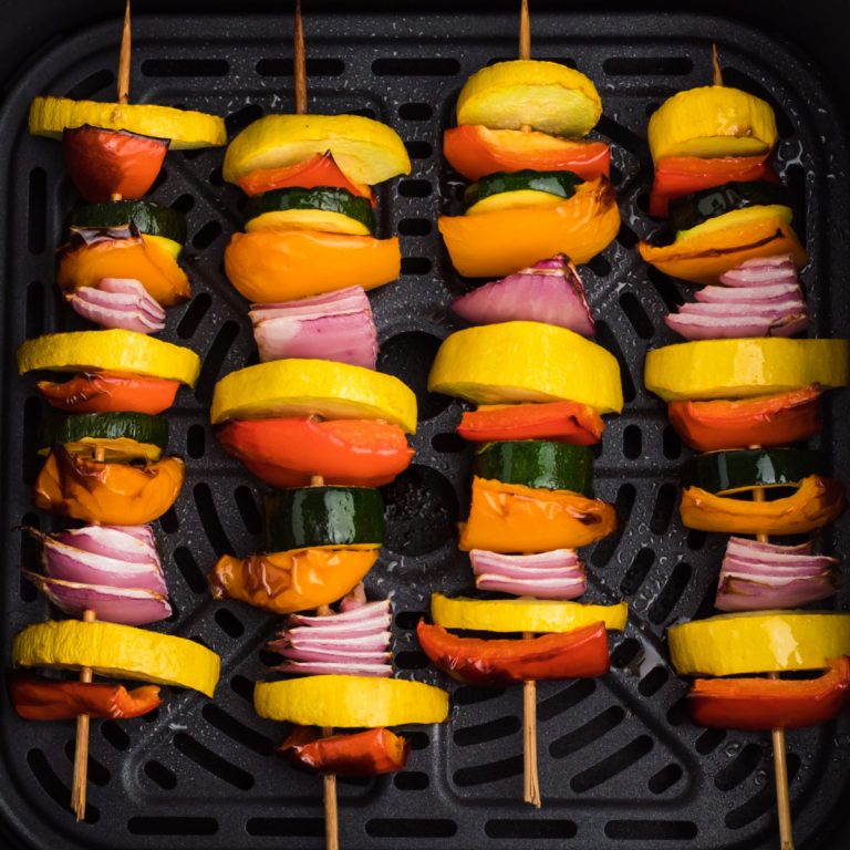 Vegetable skewers in the basket of the air fryer.