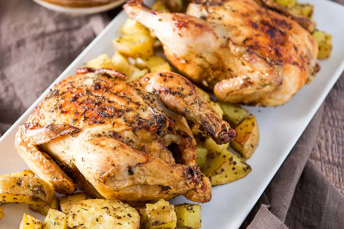 Two cornish hens on a plate.