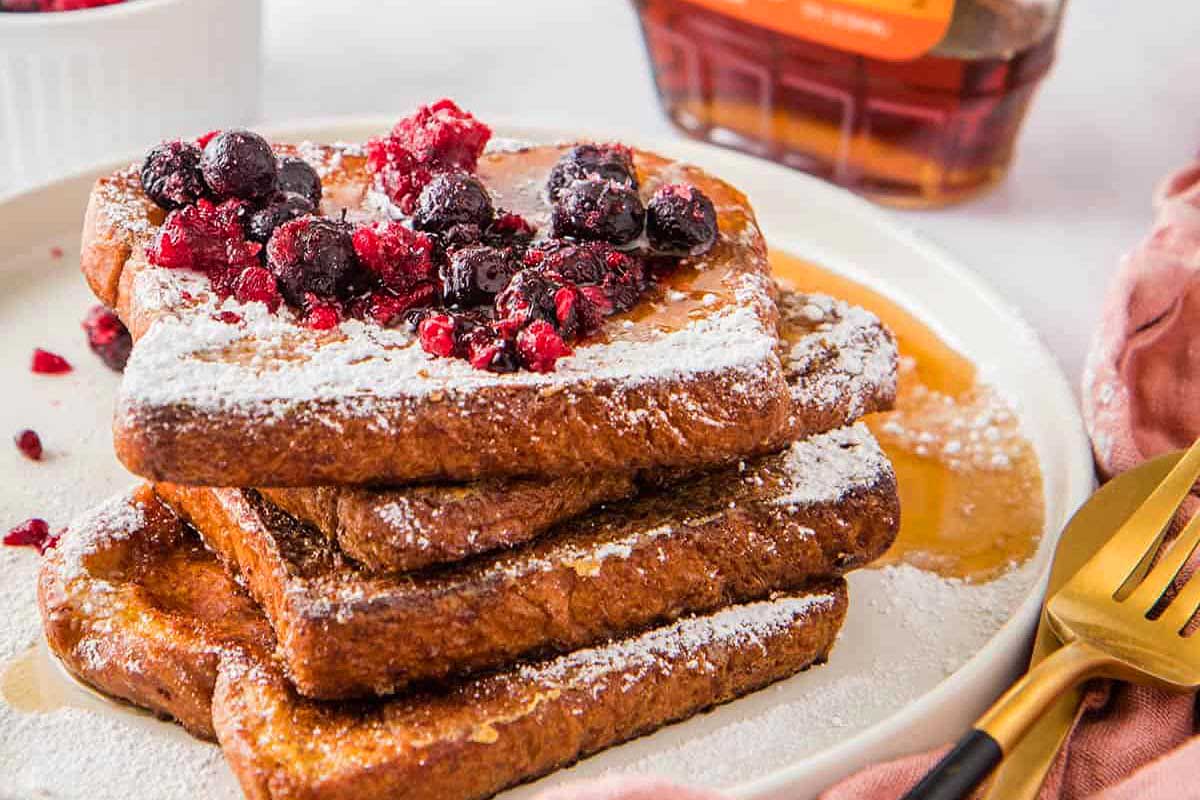French toast on a plate with berries.