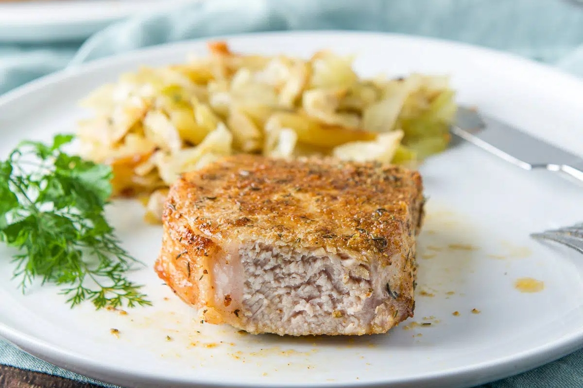 An air fried pork chop with a piece removed.