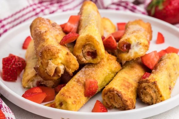 Sweet French toast roll ups filled with strawberry.
