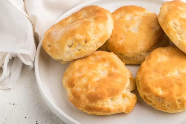 White plate with air fryer biscuits on it.