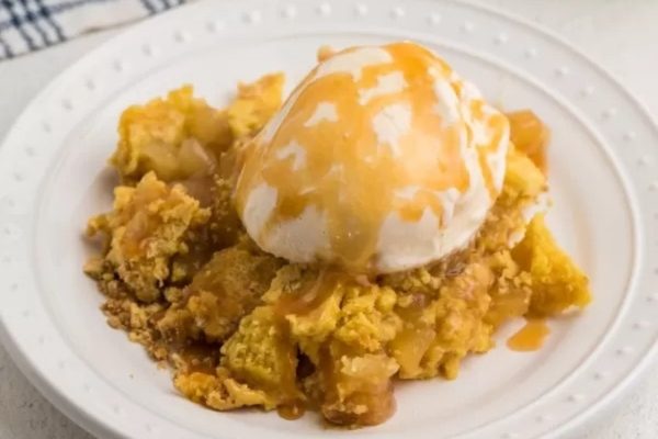 Apple cake with ice cream on a white plate.