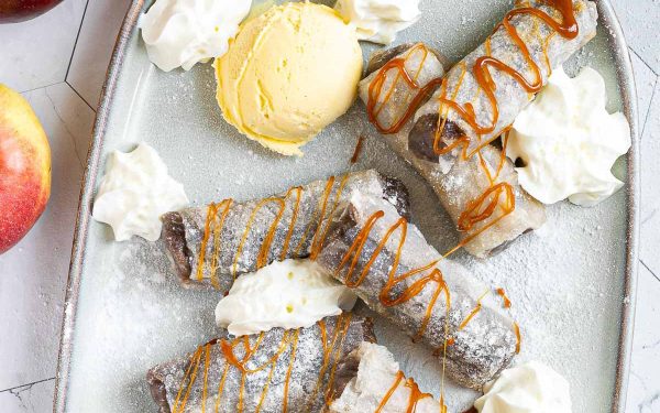 Apple Pie Spring Rolls with whipped cream and ice cream