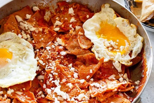 A frying pan with eggs and tortillas.