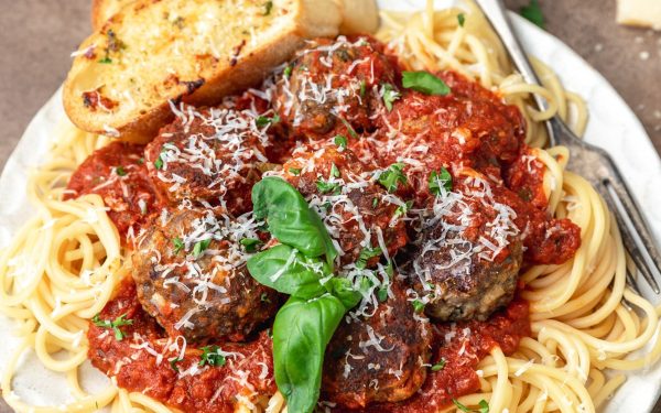Baked meatballs on spaghetti.