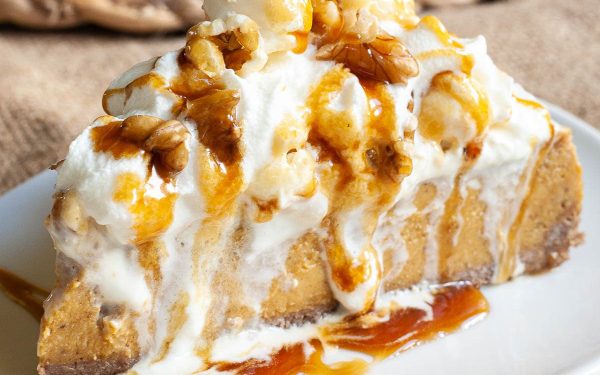 A slice of pumpkin cheesecake with toppings