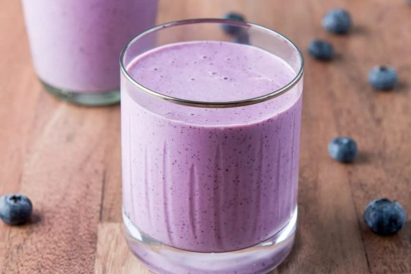 A glass of banana blueberry smoothie.