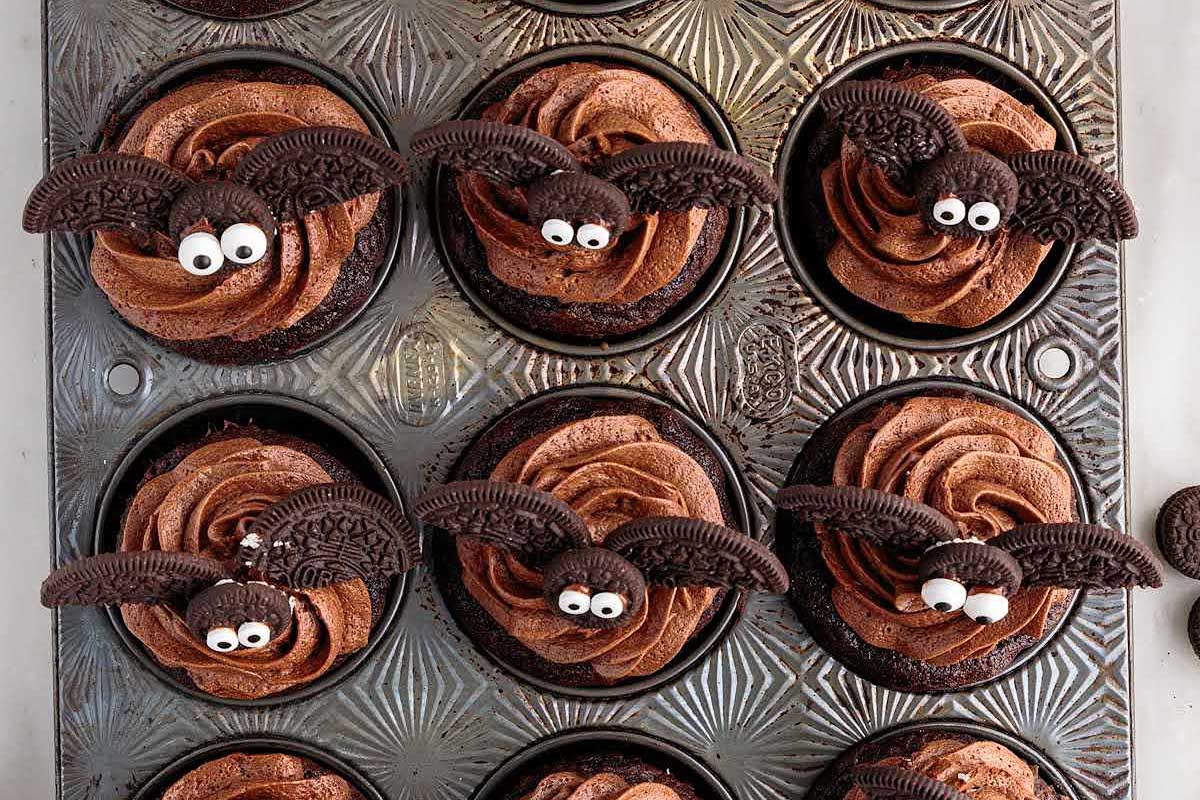 chocolate cupcakes with oreos made into bats on top.