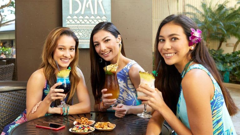 Happy women with Blue Hawaiian Drink and cocktails.