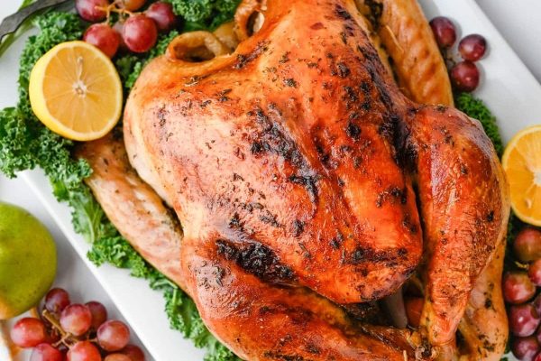 Bourbon Maple Brined Roast Turkey served with grapes and lemon. 