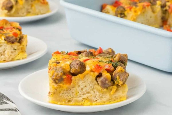 A slice of breakfast biscuit casserole on a white plate.