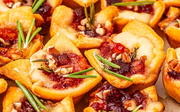 Small bread bites with cranberries on top.