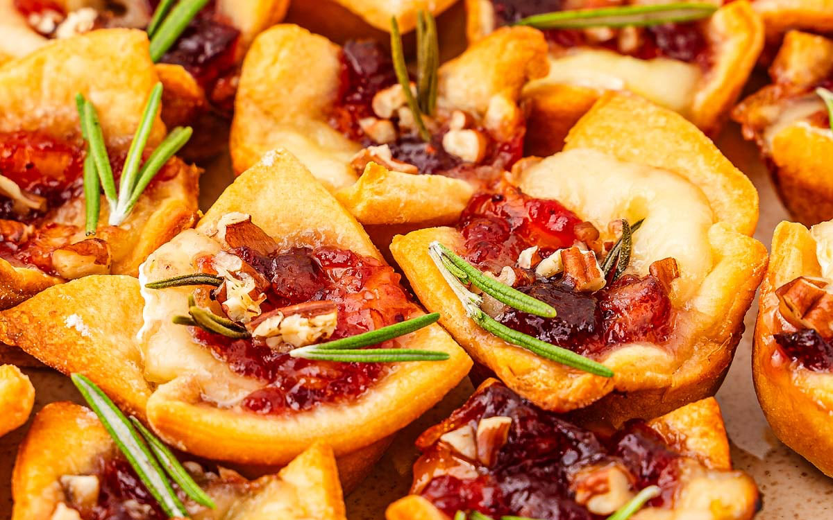Small bread bites with cranberries on top.