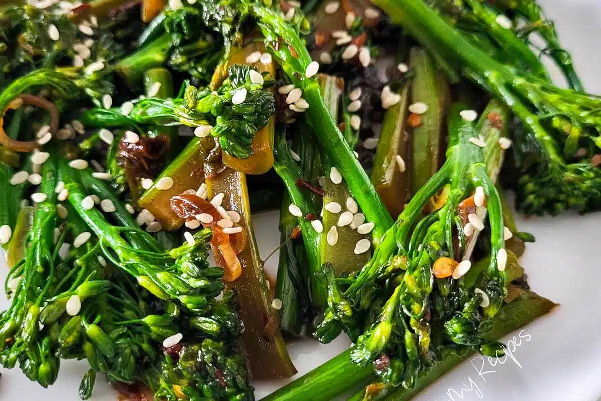 A plate of broccoli with sesame seeds and sesame oil.