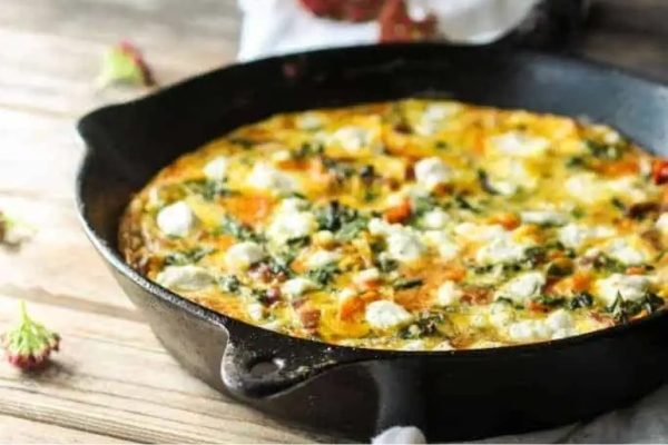 Squash and kale frittata in a skillet.