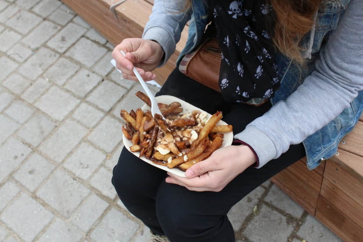 Woman eating poutine.