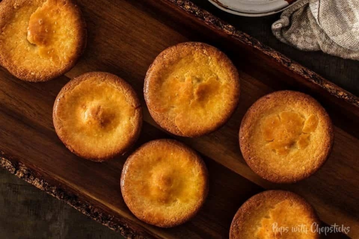 Fresh baked butter mochi muffins in a tray.