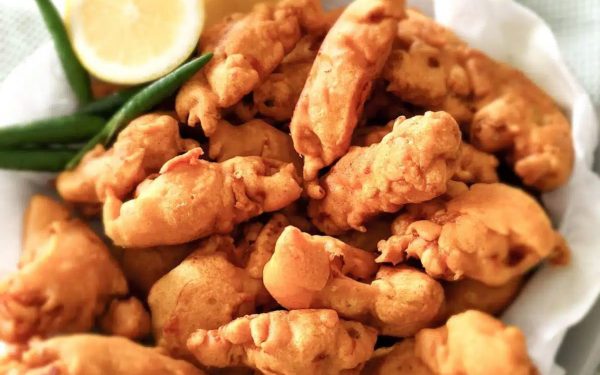 Chicken pakora with lemon on the side.