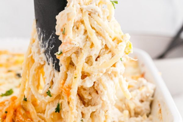 Chicken Tetrazzini scooped out with a tong.