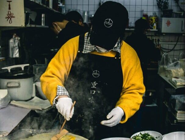 Man cooking jianbing in China.